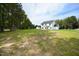 Beautiful two-story home with a well-manicured lawn and mature trees creating a serene backdrop at 196 Abingdon Farms Dr, Selma, NC 27576