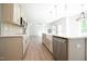 Bright kitchen features stainless steel appliances, farmhouse sink and modern countertops at 196 Abingdon Farms Dr, Selma, NC 27576