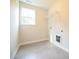 Convenient laundry room with tile flooring, a window, and a wire rack for storage at 196 Abingdon Farms Dr, Selma, NC 27576