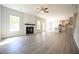 Open-concept living room flows into the kitchen with wood-look flooring and a fireplace at 196 Abingdon Farms Dr, Selma, NC 27576