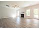 An empty living room with a fireplace and beautiful light wooden floors at 196 Abingdon Farms Dr, Selma, NC 27576
