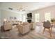 Bright, staged living room with neutral furniture, fireplace, and wood-look floors at 196 Abingdon Farms Dr, Selma, NC 27576