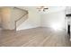 Spacious open-concept living room with wood-look floors, staircase, and natural light at 196 Abingdon Farms Dr, Selma, NC 27576