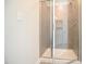Modern bathroom shower featuring neutral tile, glass door, and stylish fixtures at 196 Abingdon Farms Dr, Selma, NC 27576
