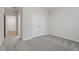 Cozy bedroom with plush carpeting, closet, and ample natural light from nearby window at 232 Berry Mill Ln # 201, Raleigh, NC 27603
