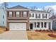 Charming two-story home featuring brick and siding, a two-car garage, and well-manicured front yard at 232 Berry Mill Ln # 201, Raleigh, NC 27603