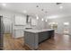 Modern kitchen with stainless steel appliances, granite countertops, and a large center island at 232 Berry Mill Ln # 201, Raleigh, NC 27603
