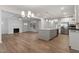 Expansive open-concept living area with hardwood flooring, fireplace, and kitchen island for modern living at 232 Berry Mill Ln # 201, Raleigh, NC 27603