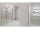 Elegant main bathroom featuring a glass-enclosed shower, soaking tub, and a window for natural light at 232 Berry Mill Ln # 201, Raleigh, NC 27603