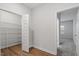 Spacious walk-in closet with wire shelving in a modern home interior, next to view to another room at 232 Berry Mill Ln # 201, Raleigh, NC 27603