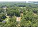 Overhead view of new home, set among lush green trees, offering privacy and a sense of seclusion at 242 Sequoia Dr, Louisburg, NC 27549