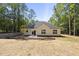 View of back of house, with white siding, black roof, and a sliding glass door to the back yard at 242 Sequoia Dr, Louisburg, NC 27549