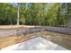 Landscaped backyard with retaining wall and concrete patio at 242 Sequoia Dr, Louisburg, NC 27549