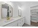 Updated bathroom with dual sinks, gold fixtures, and a large walk-in closet at 242 Sequoia Dr, Louisburg, NC 27549