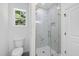 Beautiful bathroom features a glass enclosed shower with marble tiling and gold hardware at 242 Sequoia Dr, Louisburg, NC 27549