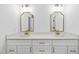 Dual vanity bathroom with updated fixtures, gold mirrors, and modern lighting at 242 Sequoia Dr, Louisburg, NC 27549