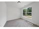 Bright, carpeted bedroom features a large window and lots of light at 242 Sequoia Dr, Louisburg, NC 27549