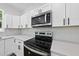 Close up of a well-equipped kitchen with modern appliances and stylish finishes at 242 Sequoia Dr, Louisburg, NC 27549