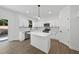 Bright, modern kitchen with white cabinets, stainless steel appliances, and an island at 242 Sequoia Dr, Louisburg, NC 27549