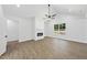 Open-concept living room with modern fireplace, large window, and vaulted ceiling at 242 Sequoia Dr, Louisburg, NC 27549
