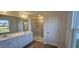 Bathroom featuring double sinks, white cabinets, and a glass shower at 466 Saint Clair Dr, Fuquay Varina, NC 27526