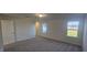 Bedroom with a door, carpet, 2 windows with lake views, and natural light at 466 Saint Clair Dr, Fuquay Varina, NC 27526