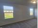 Bedroom with carpet, natural light from 2 windows, and a view to the neighborhood at 466 Saint Clair Dr, Fuquay Varina, NC 27526