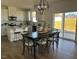 Open dining area with modern pendant lighting fixture, and views to the backyard at 466 Saint Clair Dr, Fuquay Varina, NC 27526