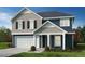 This two-story home has a gray and blue exterior with black shutters at 466 Saint Clair Dr, Fuquay Varina, NC 27526