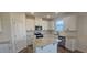 Modern kitchen with white cabinets, granite countertops and stainless steel appliances at 466 Saint Clair Dr, Fuquay Varina, NC 27526