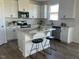 Bright kitchen showcasing white cabinets, granite countertops and stainless steel appliances at 466 Saint Clair Dr, Fuquay Varina, NC 27526