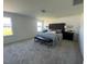 Spacious primary bedroom features a tufted headboard, bench, and ample natural light at 466 Saint Clair Dr, Fuquay Varina, NC 27526
