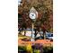 Angier town clock, surrounded by landscaping, in front of a brick wall at 81 Hank Way, Angier, NC 27501