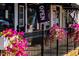 Vibrant flowers decorate the exterior of a shop with an open sign at 81 Hank Way, Angier, NC 27501