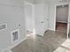 Functional laundry room with tiled flooring, white shelving, and access to other rooms at 120 Whistling Way # Cary Traditiol, Lillington, NC 27546