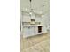 Kitchen island with ample storage, wood floors, and pendant lighting with a modern design at 2048 Abbeyhill Dr # 98, Raleigh, NC 27610