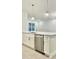 Kitchen island with stainless steel dishwasher, modern pendant lighting, and abundant storage at 2048 Abbeyhill Dr # 98, Raleigh, NC 27610
