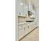 A close-up view of the kitchen, which features modern appliances, wooden floors, and white cabinets at 2048 Abbeyhill Dr # 98, Raleigh, NC 27610