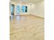 Open living space with light wood floors and a glass door to the outside at 2048 Abbeyhill Dr # 98, Raleigh, NC 27610