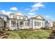 Expansive backyard featuring a covered porch and sunroom addition with multiple windows for natural light at 809 St Charles St, Durham, NC 27713