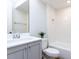 Modern bathroom with white subway tile, gray vanity, and updated fixtures at 809 St Charles St, Durham, NC 27713