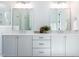 Elegant bathroom featuring double sinks, modern lighting, and a decorative plant for a spa-like ambiance at 809 St Charles St, Durham, NC 27713