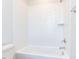 Clean white tiled shower and tub combination in a well-lit bathroom at 809 St Charles St, Durham, NC 27713