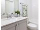 Bathroom featuring a gray vanity, quartz countertop and subway tile shower at 809 St Charles St, Durham, NC 27713
