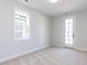 Neutral bedroom with carpet, window and exterior door at 809 St Charles St, Durham, NC 27713