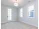 Sunlit bedroom with light carpet and a door leading to a balcony at 809 St Charles St, Durham, NC 27713