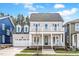 Charming two-story home with a welcoming front porch and balcony, complemented by lush landscaping at 809 St Charles St, Durham, NC 27713