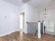 Upstairs hallway with hardwood floors, staircase, and stylish lighting fixture at 809 St Charles St, Durham, NC 27713