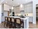 Gourmet kitchen boasts a large center island, stainless steel appliances, and grey cabinetry at 809 St Charles St, Durham, NC 27713