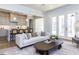 Open concept living room featuring a light sofa, wood floors, and light grey cabinets at 809 St Charles St, Durham, NC 27713